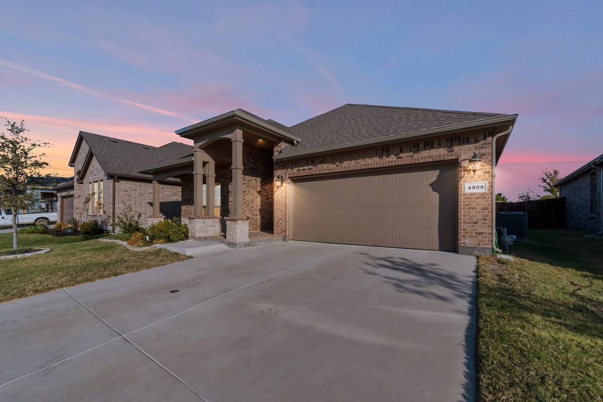 Sunny brick home exterior of an MHousing Stays-managed property near Keller, Texas